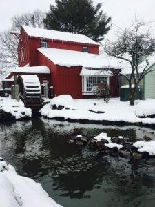 Snow covered building and mill at the Olde Mistick Village.