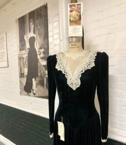 Photo of an antique black velvet dress with a white lace collar made at the Velvet Mill during it's Heyday