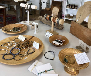 Display of jewelry in wooden bowls. 