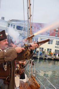 Pirates fire recreation muskets during the Mystic Pirate Invasion