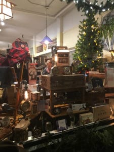 A holiday window display with vintage radios and clocks. 