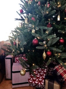Close up of Christmas Tree and festive wrapped gifts