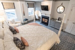 hotel bedroom with a fireplace in in stonington, ct for a corporate retreat