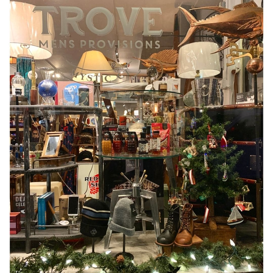 Downtown Mystic Holiday Window Shopping at Trove shows men's boots, gifts, and home decor. 