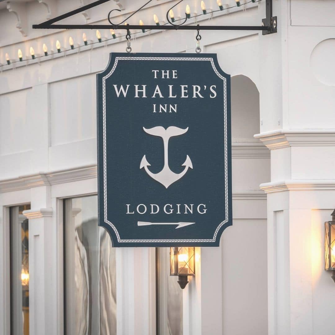 A handcarved sign pointing guests to the lobby of The Whaler's Inn. 