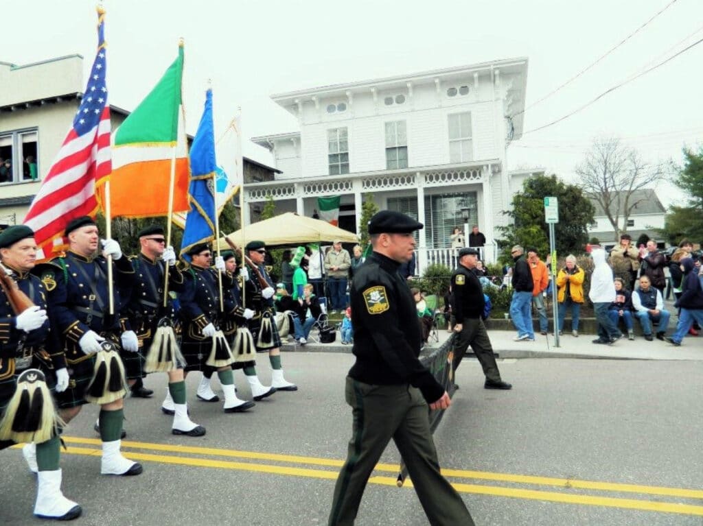 men marching down street in Mystic Irish Parade