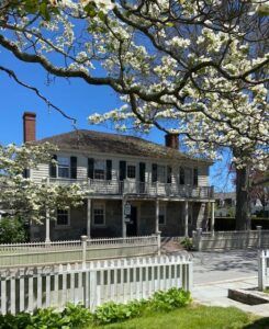 Historic House surrounded by flowers in downtown Mystic