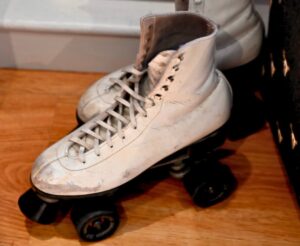 Pair of vinatge ice skates in the corner of a store 